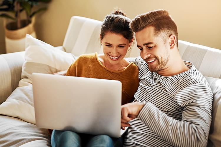 Smiling woman looking at laptop